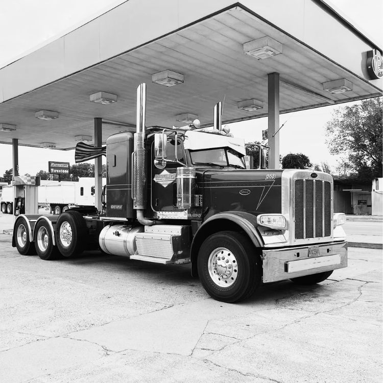 equipment transport near De Queen AR heavy-duty Peterbilt semi-truck parked at fuel station