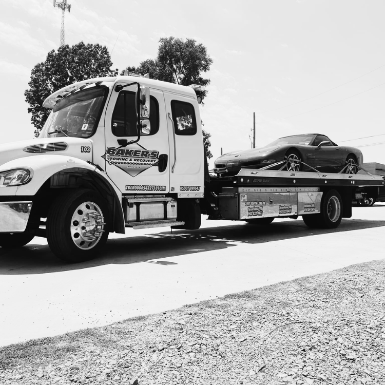 light duty towing De Queen AR flatbed tow truck transporting a sports car