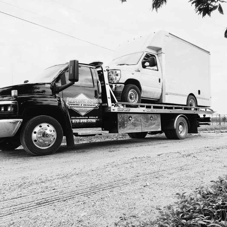 RV Tow Service De Queen AR flatbed tow truck transporting a commercial box van